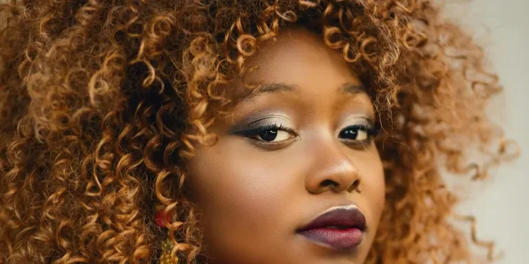 Closeup image of a woman with 3c curly brown hair