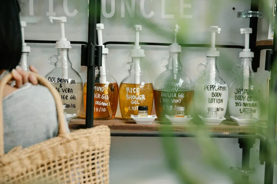 Display of eco-friendly personal care products in refillable bottles on a shelf, promoting sustainability
