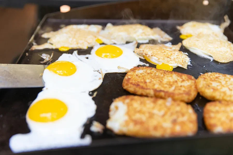 Electric griddle on high heat cooking eggs for breakfast