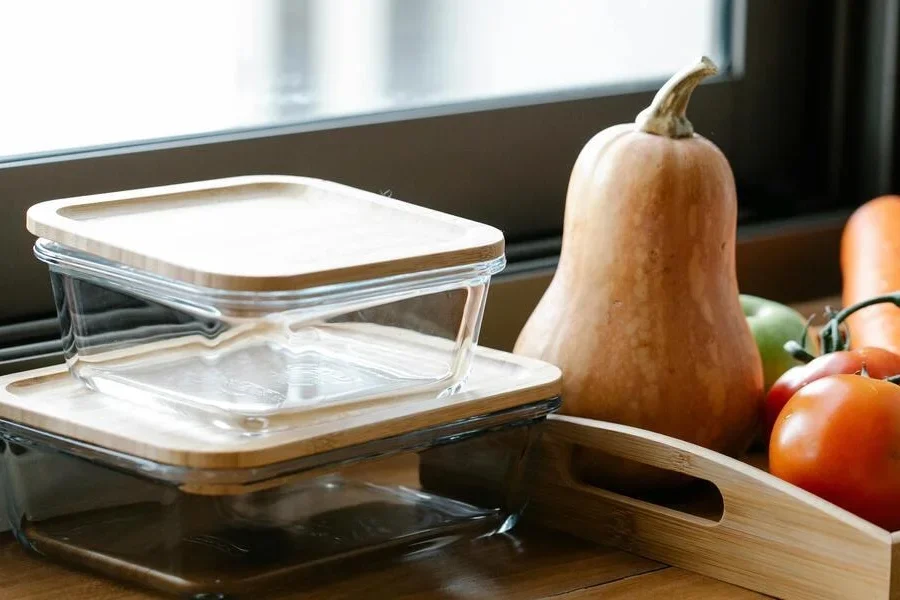 Recipientes de vidrio junto a verduras en la encimera de la cocina.