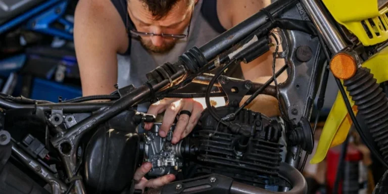Mechanic focused on repairing a motorcycle engine in garage setting