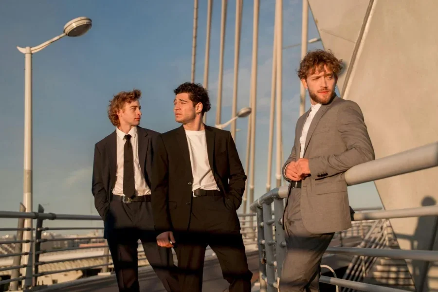 Men in White Shirts and Blazers Standing Near Metal Handrails