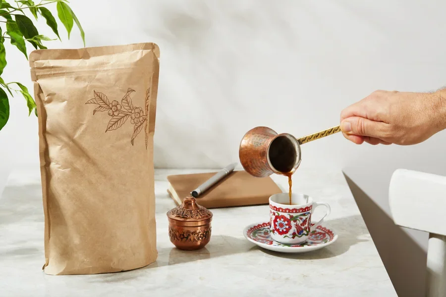 Turkish Coffee set up. Serving the Turkish Coffee from cezve on marble table in sunny summer day