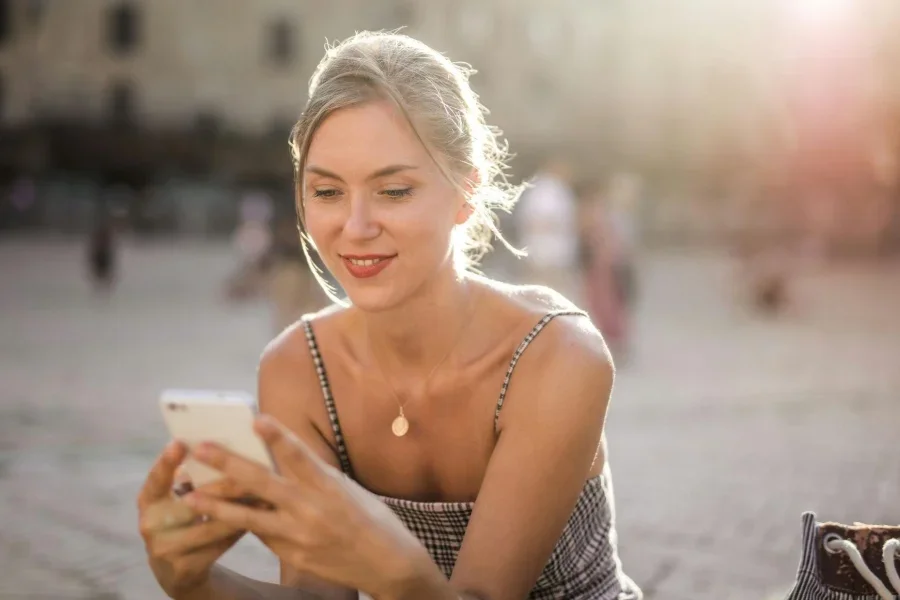 Woman in White and Black Stripe Spaghetti Strap Top Holding White Ceramic Mug