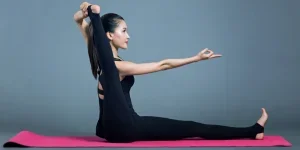 woman in black tank top and black pants doing yoga