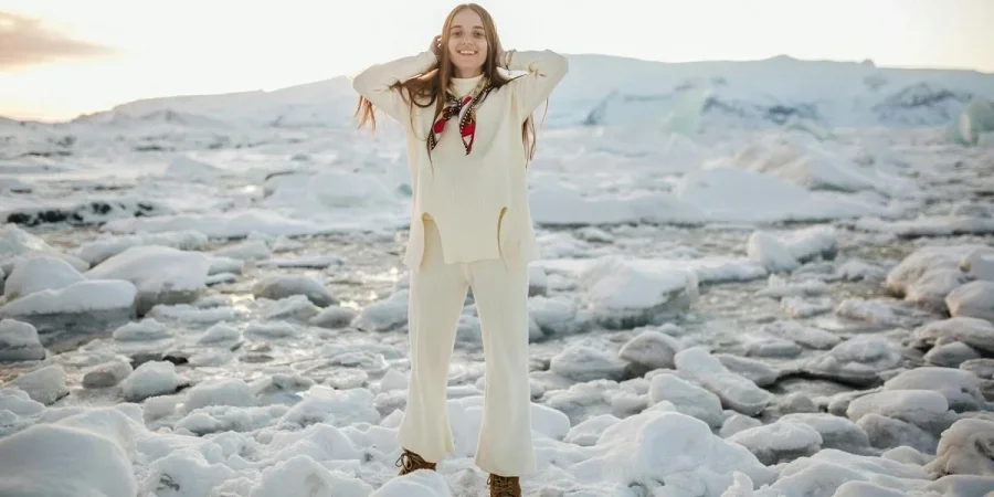 A Woman Standing on Snow Covered Ground