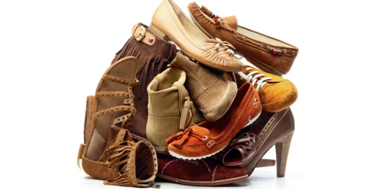 A pile of assorted vintage footwear in earthy brown tones