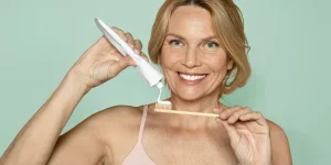 A woman is going to brush her teeth.