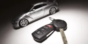 Car Key, REmote and Automobile Blurry in Background