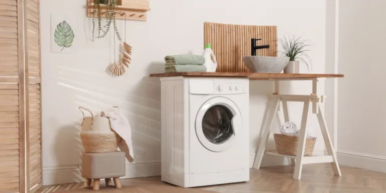 Laundry Room Interior with Modern Washing Machine and Stylish Vessel Sink on Wooden Countertop