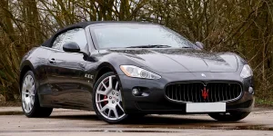 Sleek Maserati convertible parked outdoors, reflecting elegance and power
