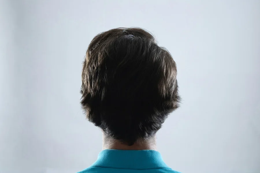 The back of a man's head in a blue shirt