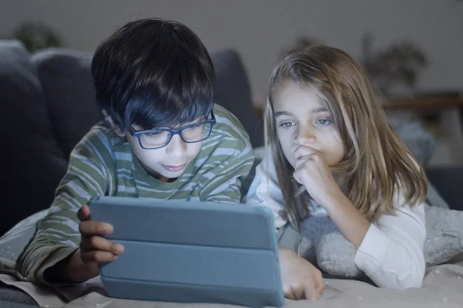 Two kids looking at a tablet
