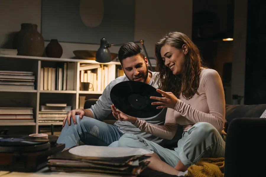 Two people looking at a record