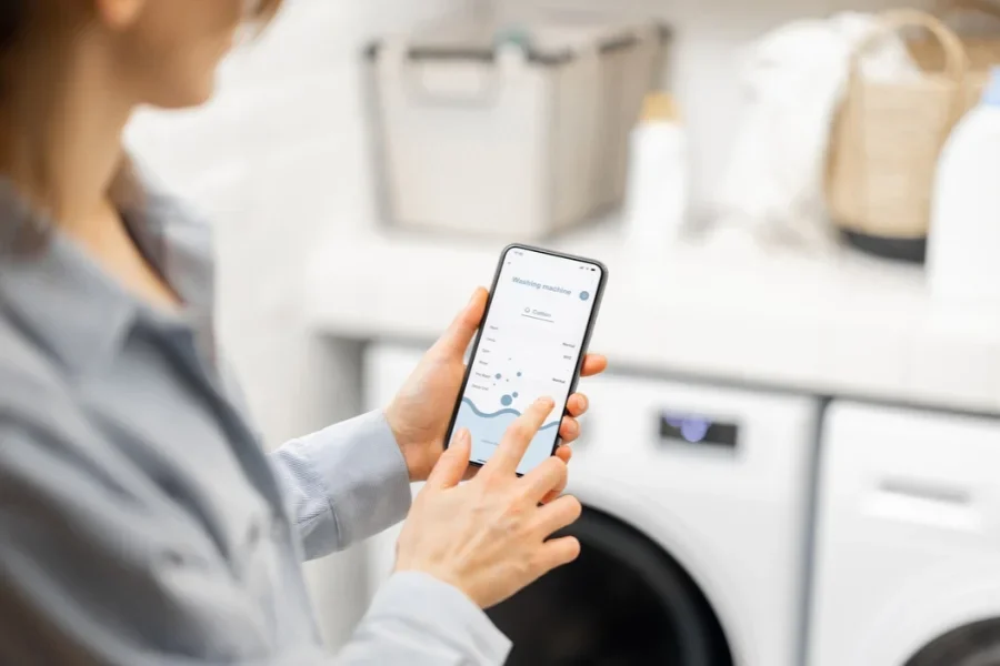 Woman Controls Washing Machine with a Smartphone