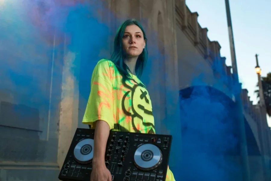 Woman in Yellow Shirt Sitting on Black and White Concrete Building