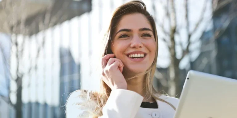 Woman smiling holding a tablet