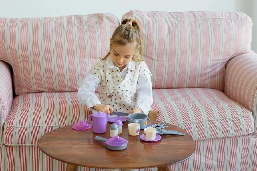Young Girl Enjoying Play Tea Set at Home
