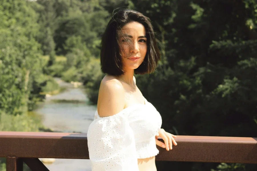 Young Woman Standing on the Bridge in Summer