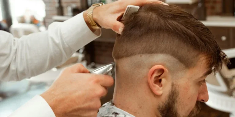 man in white dress shirt cutting hair of man