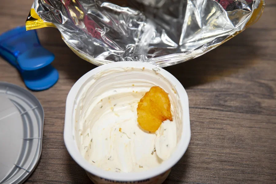 Chip sitting in food container with blue bag clip adjacent