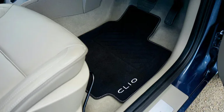 Close-up of Renault Clio car interior showcasing a customized floor mat with branding