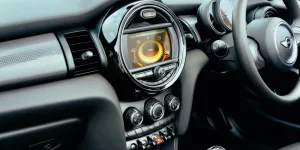 Close-up view of a Mini Cooper's dashboard interior, featuring modern controls and sleek design