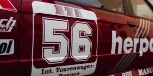 Detailed view of a racing car featuring number 56 with sponsor logos