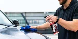 Man Cleaning the Hood of a Car