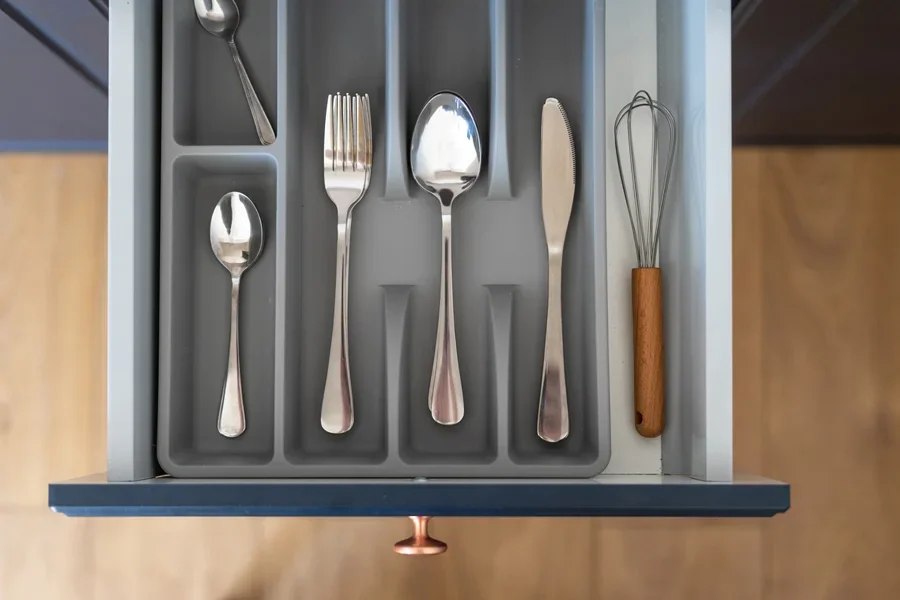Plastic utensil organizer with silverware neatly stacked inside