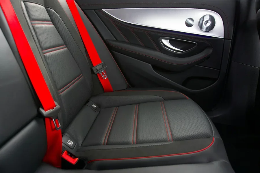 Sleek car interior featuring black and red seats with contemporary design elements