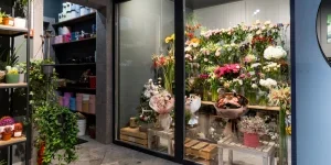 Small flower fridge with various types of cut flowers inside