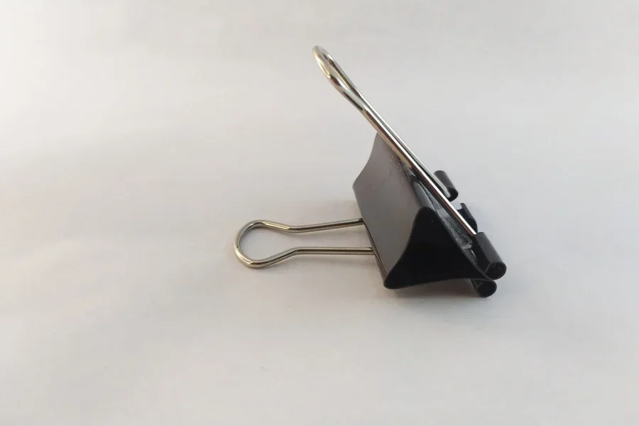 Small metal spring-loaded bag clip with black plastic body