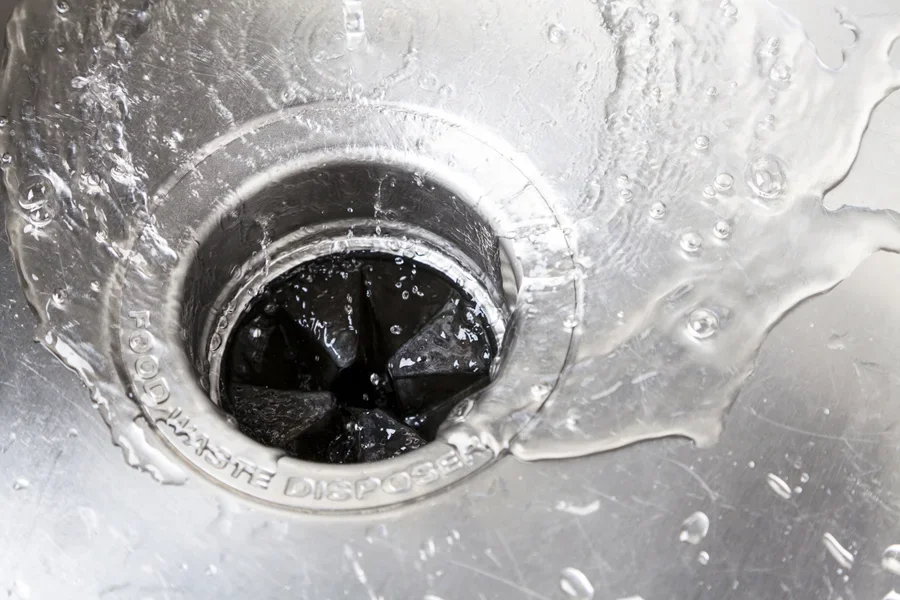Stainless steel sink with hot water flushing down the drain