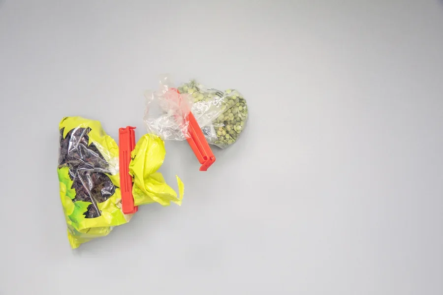 Two long plastic bag clips used on food packages