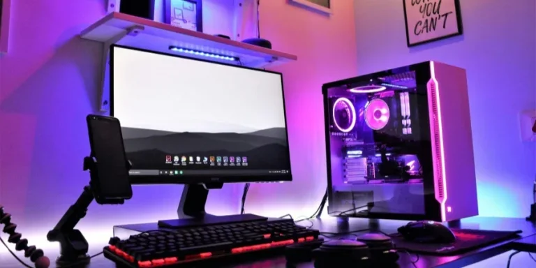 Computer with Headphones and a Smartphone on the Desk