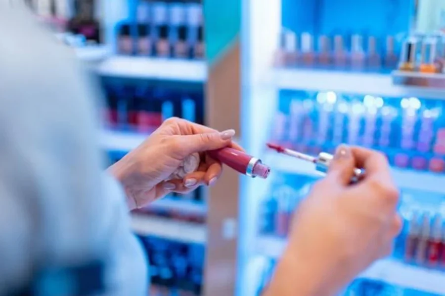 Looking for perfect shade of lip gloss at makeup stand