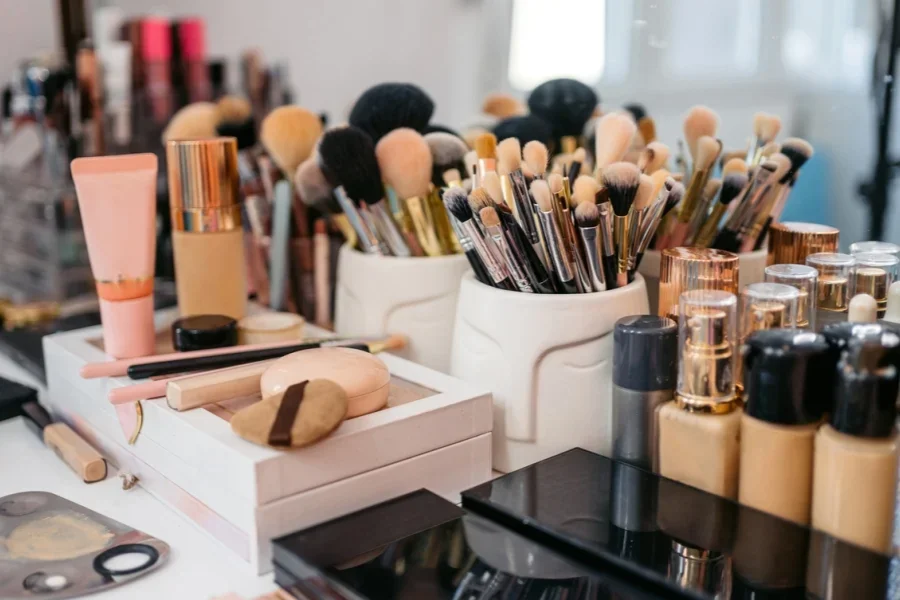 Makeup Brushes And Beauty Products Arranged On A Desk
