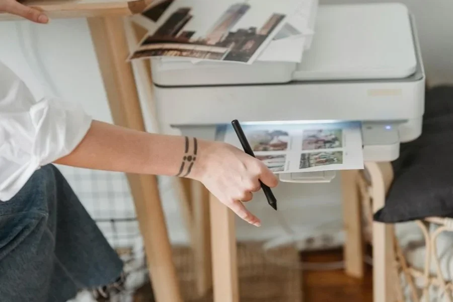 Woman Printing Photos on Paper While Forking at Home