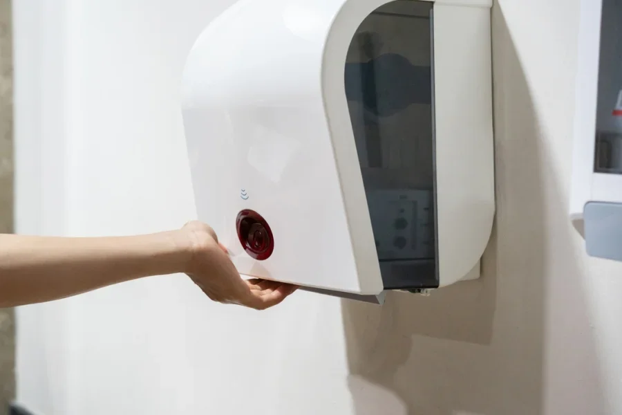 Young Boy Dries Wet Hands with an Electric Hand Dryers
