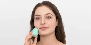 Young Woman with Turquoise Makeup Sponge