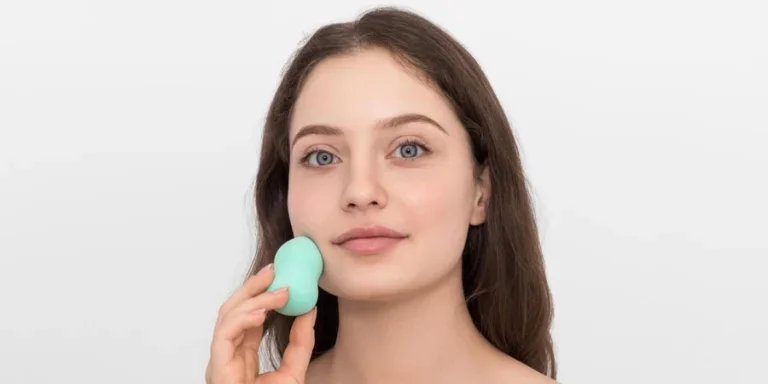 Young Woman with Turquoise Makeup Sponge