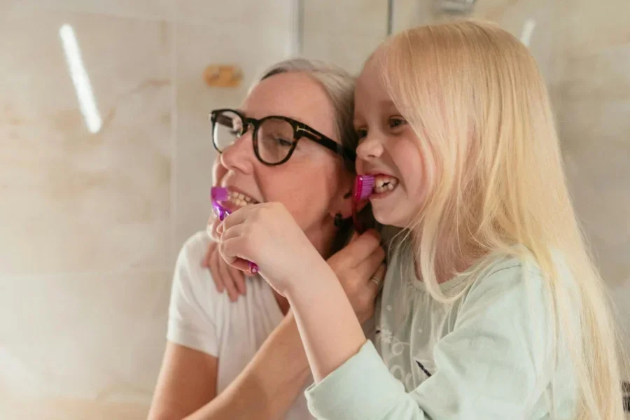 A Woman and her Granddaughter Brushing their Teeth