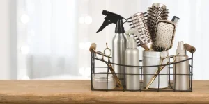 Barber tools on wooden table with blurred beauty salon background