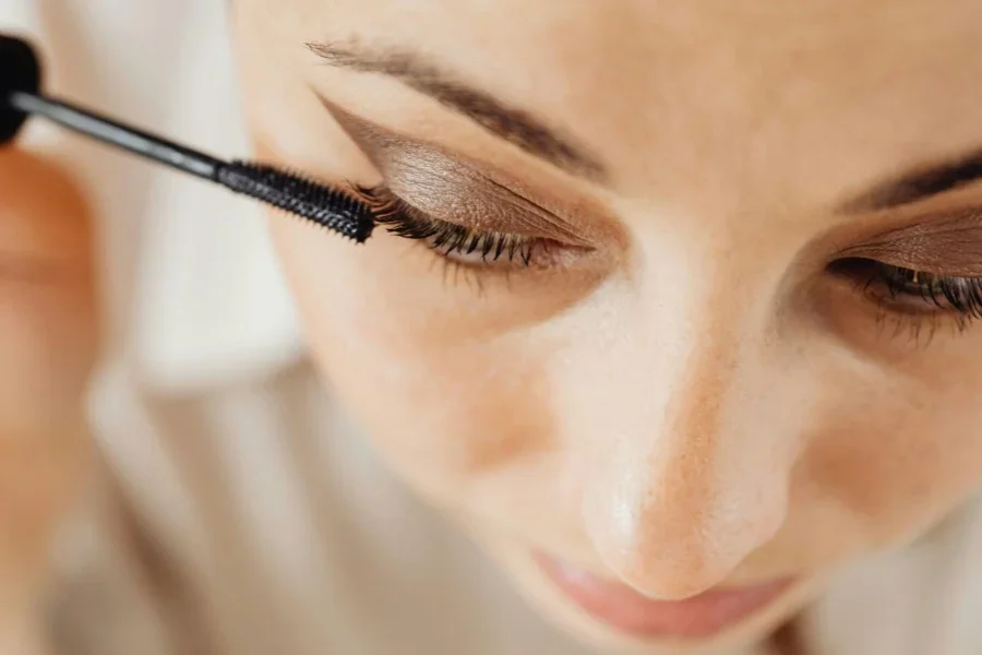 Close-up of a Woman Applying Mascara