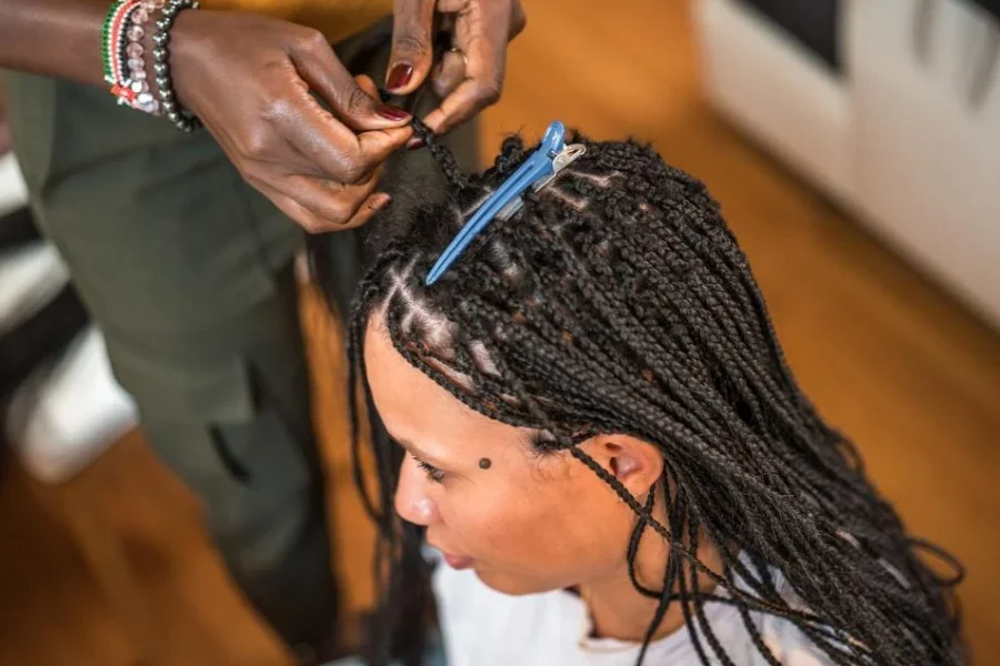 Hairstylist Working on Plaits And Twists