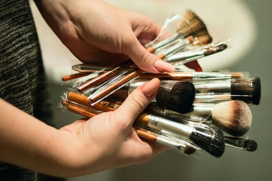 Person Holding Makeup Brushes