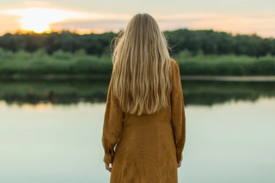 Rear View of Blonde Woman near a River