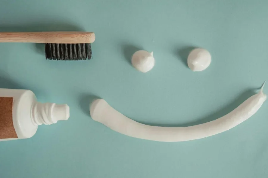 Toothbrush, a a Tube of Toothpaste and a Smile Painted with Toothpaste