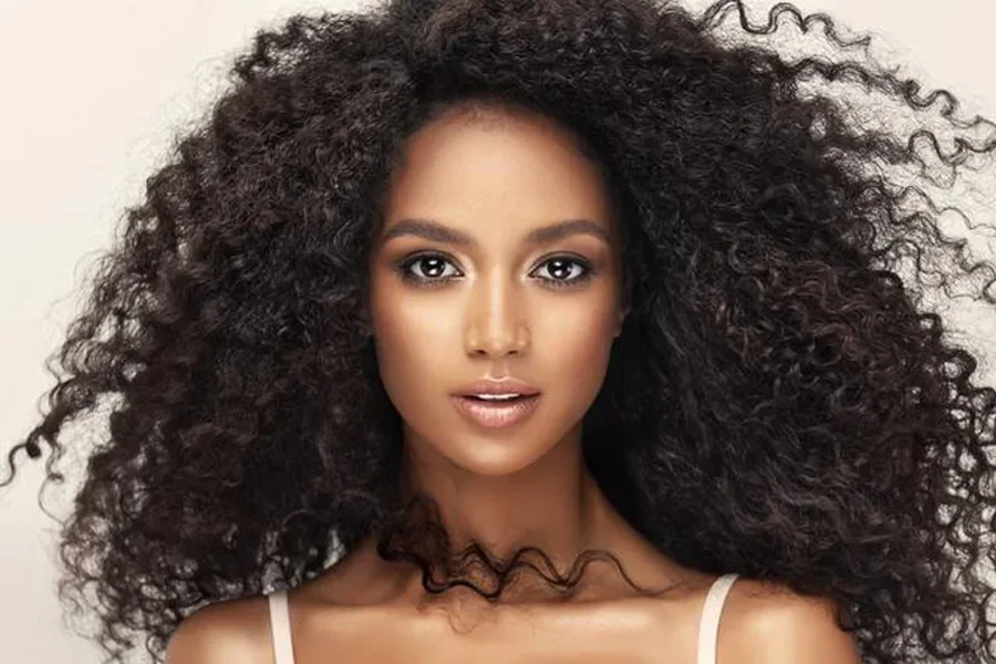 Young Beauty With Long Dense Curly Hair